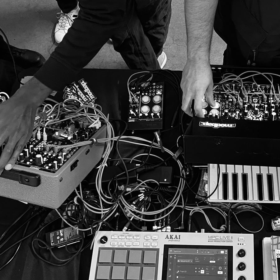 Trinity, Transit and Per4mer patched up beside an MPC Live II on a table of cables